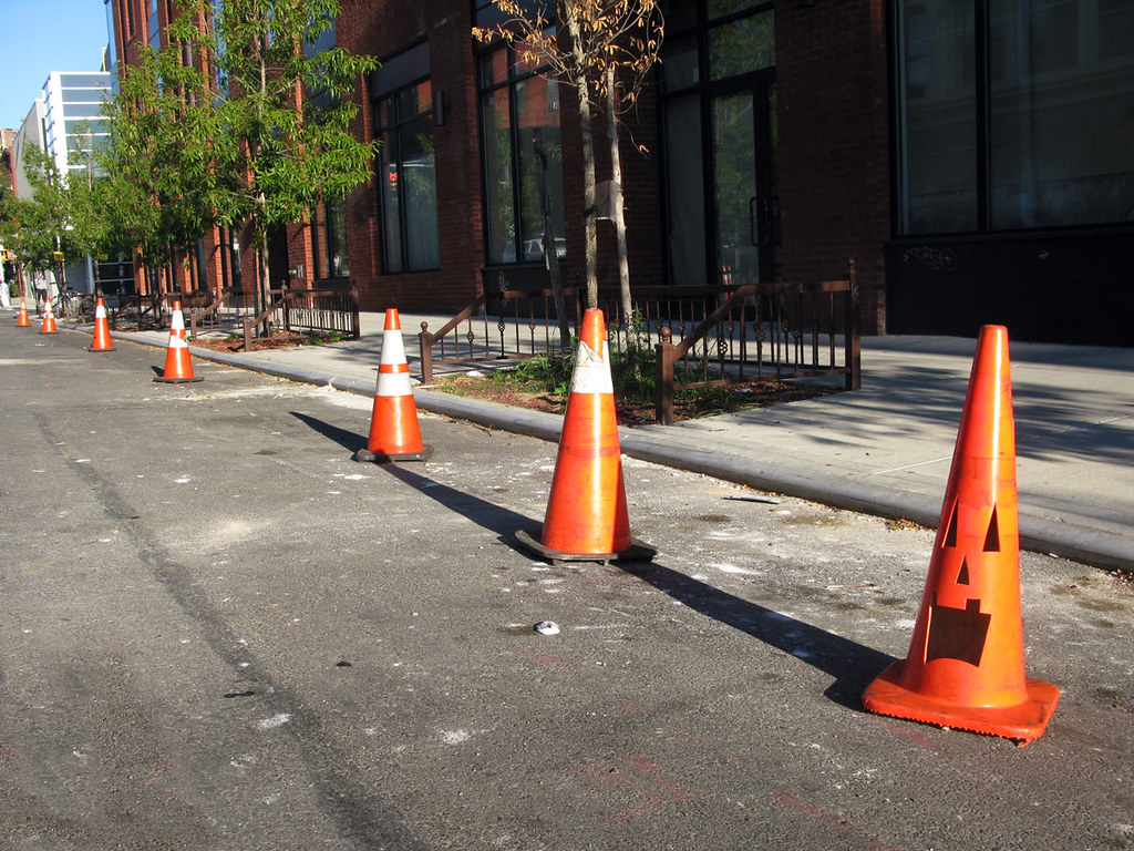 Row of orange traffic cones along a street