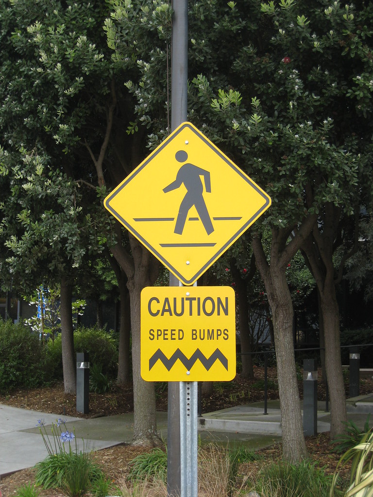 Caution speed bumps sign